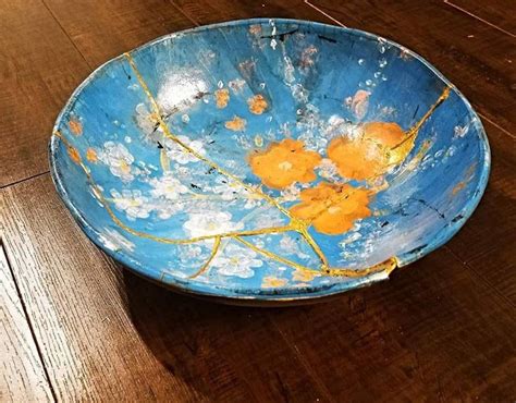 a blue bowl sitting on top of a wooden floor