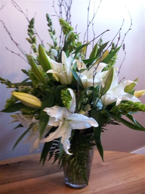 Vased arrangement of white stargazer lilies #paigesloveyoubunches | Funeral floral, Stargazer ...