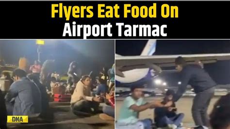 IndiGo Passengers Eat Food On Airport Tarmac Next To Plane After 12-Hour Flight Delay - YouTube