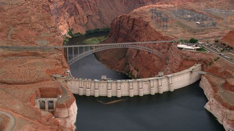 5.5K stock footage aerial video of flying by Glen Canyon Dam and Bridge, Arizona, zoom to wider ...