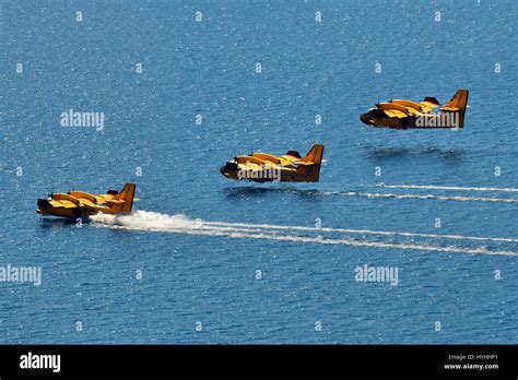 Composite of three aerial water bomber seaplanes landing on the water Stock Photo - Alamy