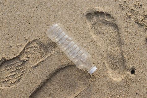 Plastic Water Bottle Pollution on the Beach with Human Footprint in the Sand. Stock Photo ...