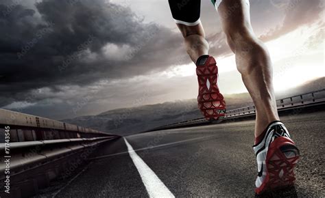 Sports background. Runner feet running on road closeup on shoe. Stock Photo | Adobe Stock