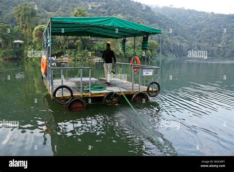 Hand-pulled raft (pedestrian ferry) across Phewa Lake (Fewa Lake) channel to Fish Tail (Fishtail ...