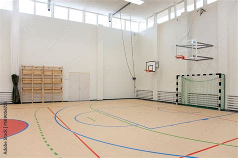 Indoor basketball court at a school. Wooden floor and marked court, a ...