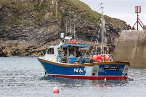 Fishing Boat in Port Isaac in Cornwall on August 13, 2013. Three ...