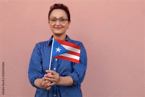 Puerto Rico flag. Woman holding Puerto Rico flag. Nice portrait of middle aged lady 40 50 years ...