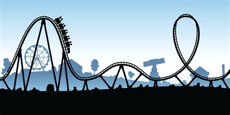 an amusement park roller coaster silhouetted against a blue sky with buildings in the background