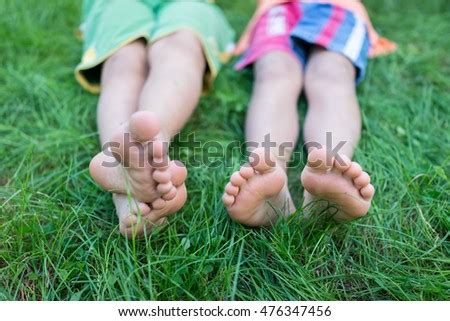 Happy Friends Sitting On Grass Barefoot Stock Photo 96942986 - Shutterstock