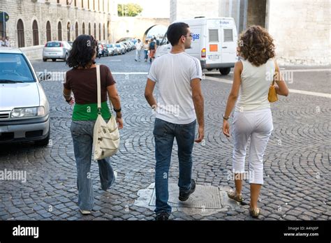 Three people walking in Bari s back streets Bari Italy Stock Photo - Alamy