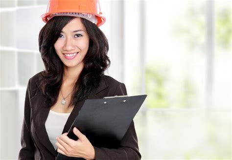 Premium Photo | Young woman architect with orange helmet