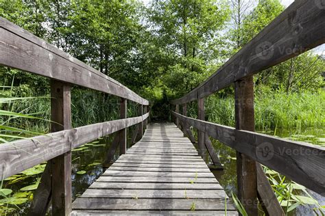 old wooden bridge built on the lake 9712911 Stock Photo at Vecteezy