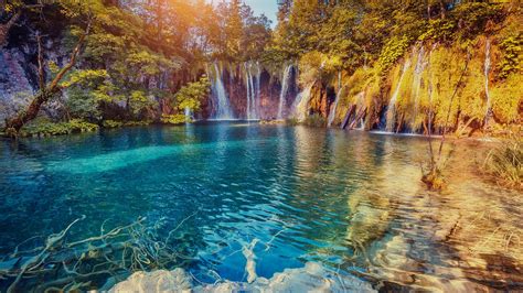 Majestic view on turquoise water and sunny beams, Plitvice Lakes National Park, Croatia ...