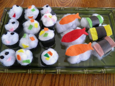 sushi rolls are arranged on a tray with chopsticks in the shape of animals