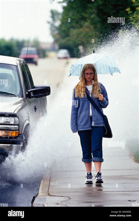 Girl walking in the rain Stock Photo - Alamy