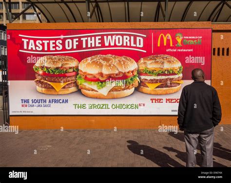 JOHANNESBURG, SOUTH AFRICA -McDonald's Restaurant billboard and man ...