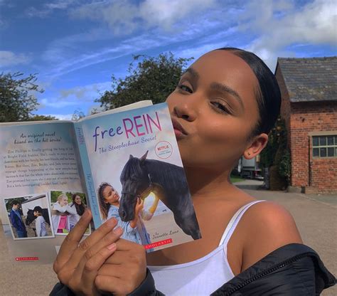 a woman holding up a book in front of her face