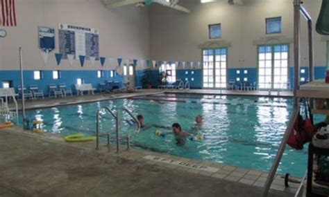 an indoor swimming pool with people in it