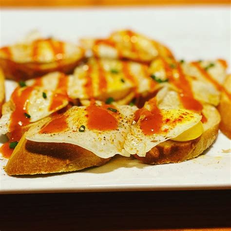 Quail egg crostini with black truffle hot sauce. | Food, Yummy food, Ethnic recipes