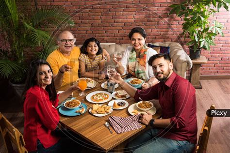 Image of Indian family eating food at home or restaurant-TY786991-Picxy