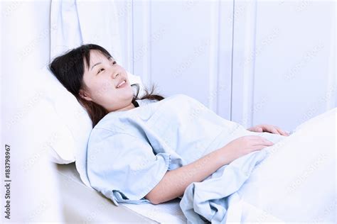 Pregnant woman lying in hospital bed Stock Photo | Adobe Stock