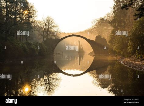 The Rakotzbrücke in the Rhododendronpark Kromlau at sunrise, Gablenz ...