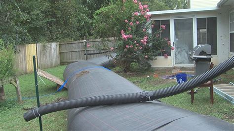 Fed up with flooding, North Charleston family fights water with water ...