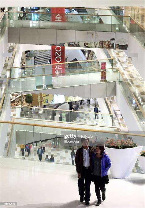 A couple walks through the Tongzhou Wanda Plaza shopping mall,... News Photo - Getty Images