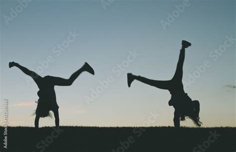 Little girl silhouette doing cartwheels Stock Photo | Adobe Stock