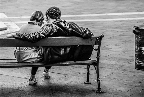 Grayscale Photo of Two Person Sitting on a Bench · Free Stock Photo