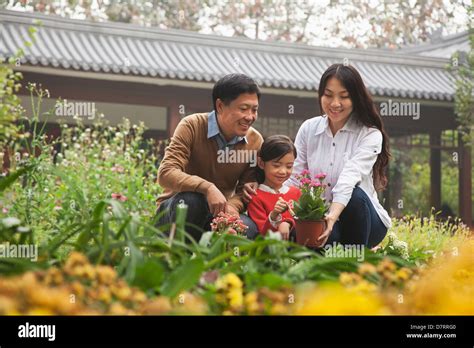 Happy family in garden Stock Photo - Alamy