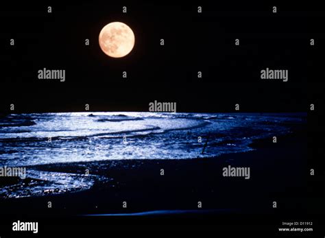 FULL MOON OVER OCEAN WAVES Stock Photo - Alamy