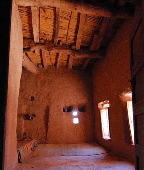 Mud brick house interior with clay-lined walls, small windows and wooden roof | Mud house ...