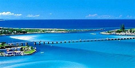 an aerial view of the ocean and bridge