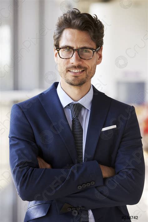 Portrait of young professional man in suit, arms crossed - stock photo ...