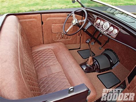 the interior of an old fashioned car with leather seats and steering wheel covers on display
