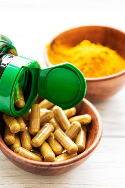 Premium Photo | Turmeric powder and capsules