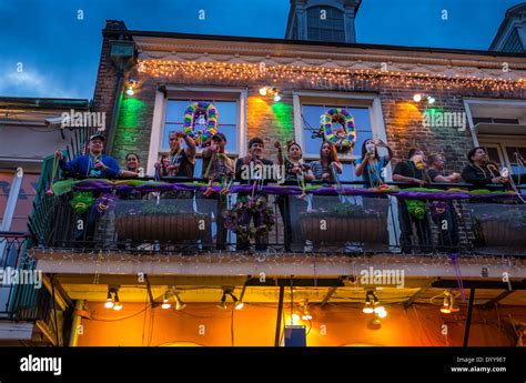 People showing Mardi Gras beads in balcony over Bourbon Street in the New Orleans Stock Photo ...