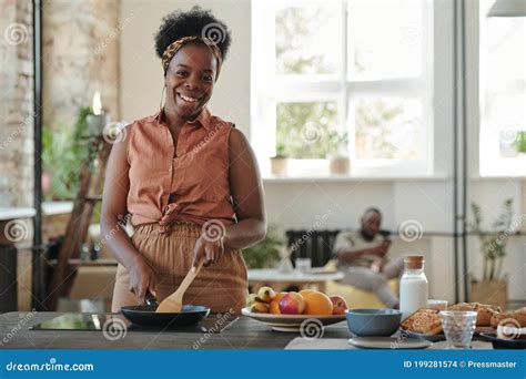 Young Happy Woman of African Ethnicity Cooking Dinner for Her Family by Stove Stock Photo ...