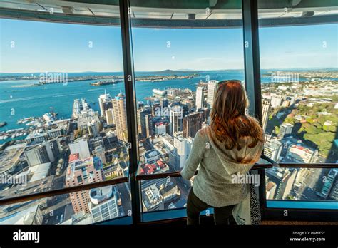 Tourist enjoying the view from the observation deck of the Sky Tower ...