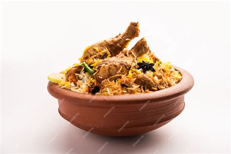 Premium Photo | Dum Handi chicken Biryani is prepared in an earthen or clay pot called Haandi ...