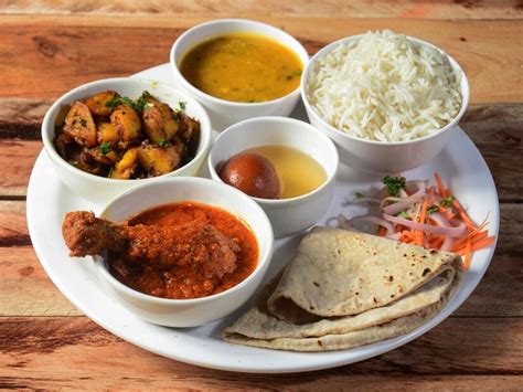 Premium Photo | Indian NonVeg Thali food platter consists variety of veggiesChicken meat lentils ...