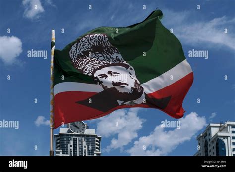 The Chechen flag bearing the image of Akhmad Kadyrov former Head of the Chechen Republic ...