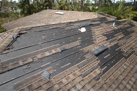 Damaged House Roof with Missing Shingles after Hurricane Ian in Florida. Consequences of Natural ...