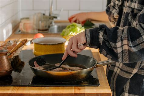 Person Holding Black Ceramic Bowl With Soup · Free Stock Photo
