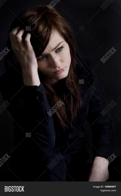 Young sad girl alone in a dark room Stock Photo & Stock Images | Bigstock