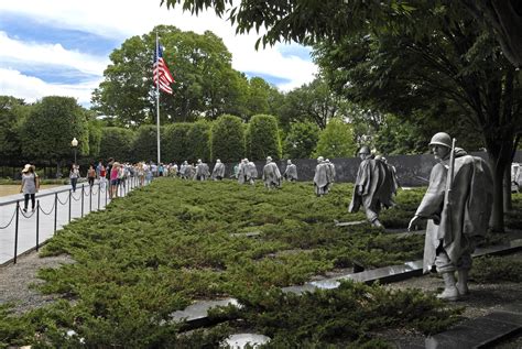 Tourists visit the Korean War Veterans Memorial in Washington, D.C ...