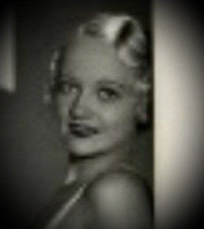 a black and white photo of a woman with blonde hair in an old fashion dress