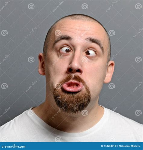 Portrait of a Man Making Funny Face Against Gray Background Stock Photo - Image of alone ...