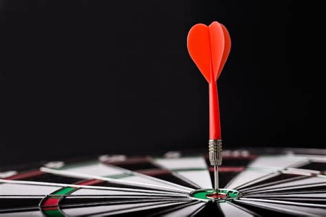 Premium Photo | Darts board with red dart arrow on center of dartboard. targeting, business and ...